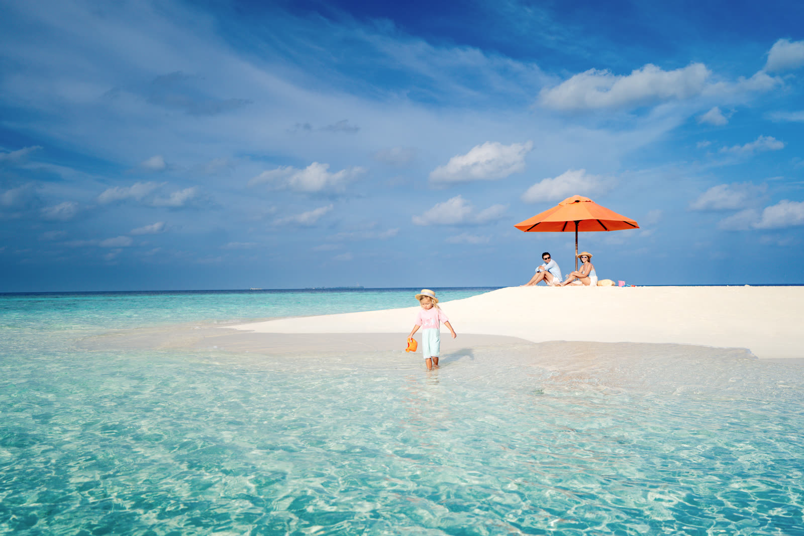 Sandbank scene with a single orange umbrella