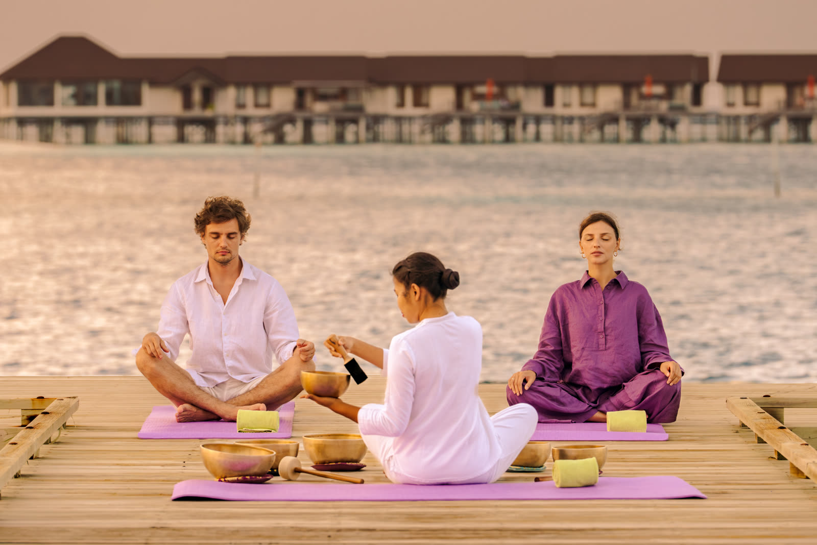 Wellness scene: sound bath on an overwater deck